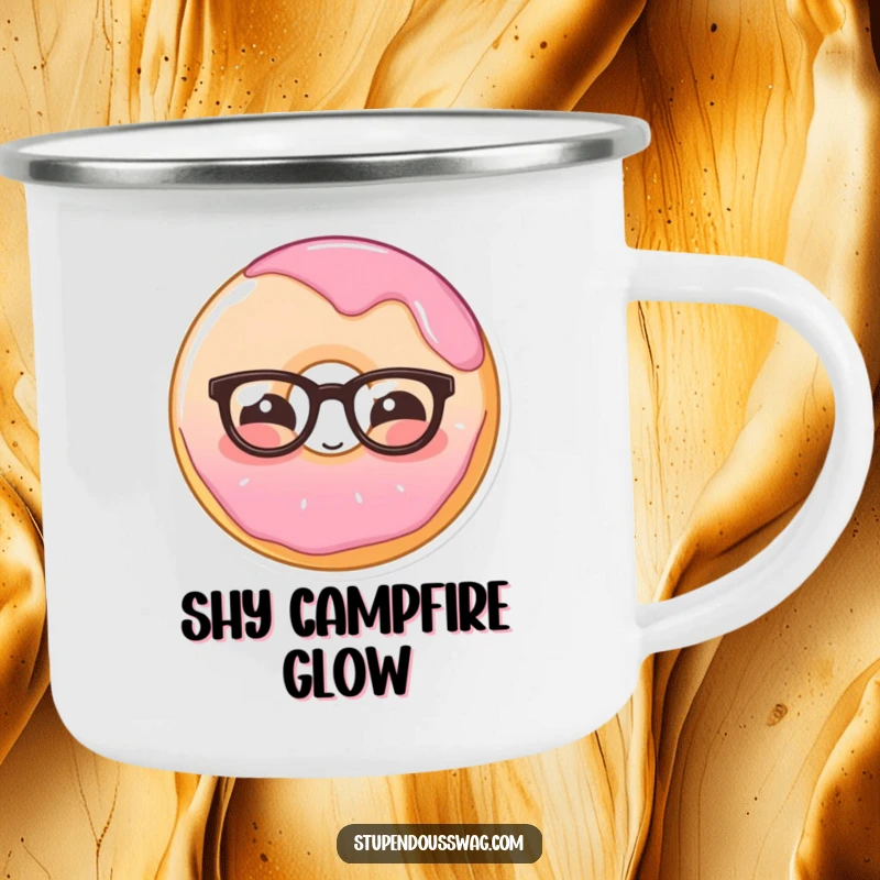 Funny camping mug showing a shy donut wearing glasses, blushing, ready for campfire stories and gentle amusement.