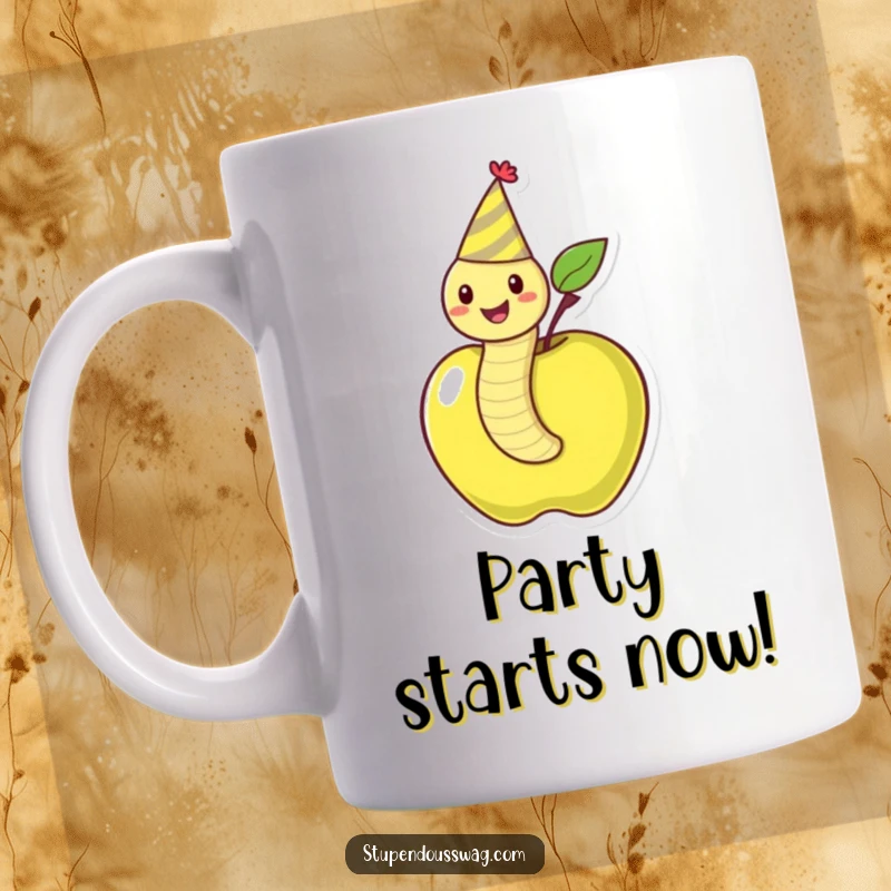 Funny mug depicting a cheerful worm sporting a party hat, joyfully wiggling out of a ripe apple, radiating pure fun.