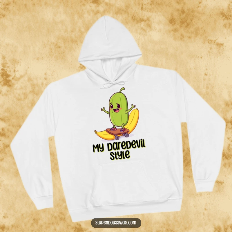 Funny hoodie with a mischievous pickle skateboarding down a banana peel, ensuring warm, humorous comfort.