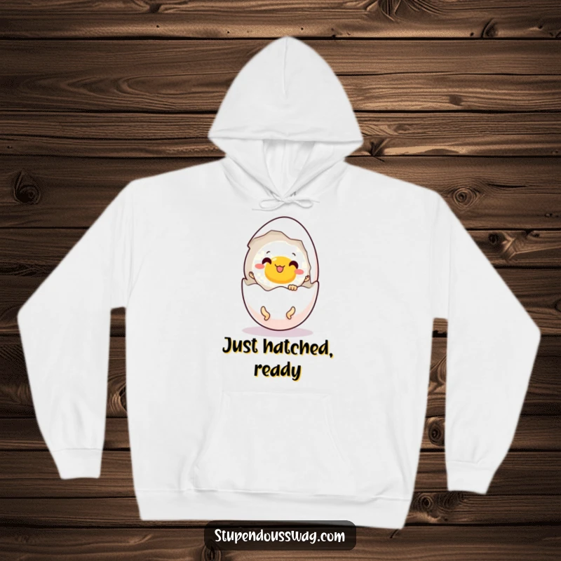 Funny hoodie depicting a surprised egg cracking open to reveal tiny legs enthusiastically dancing.