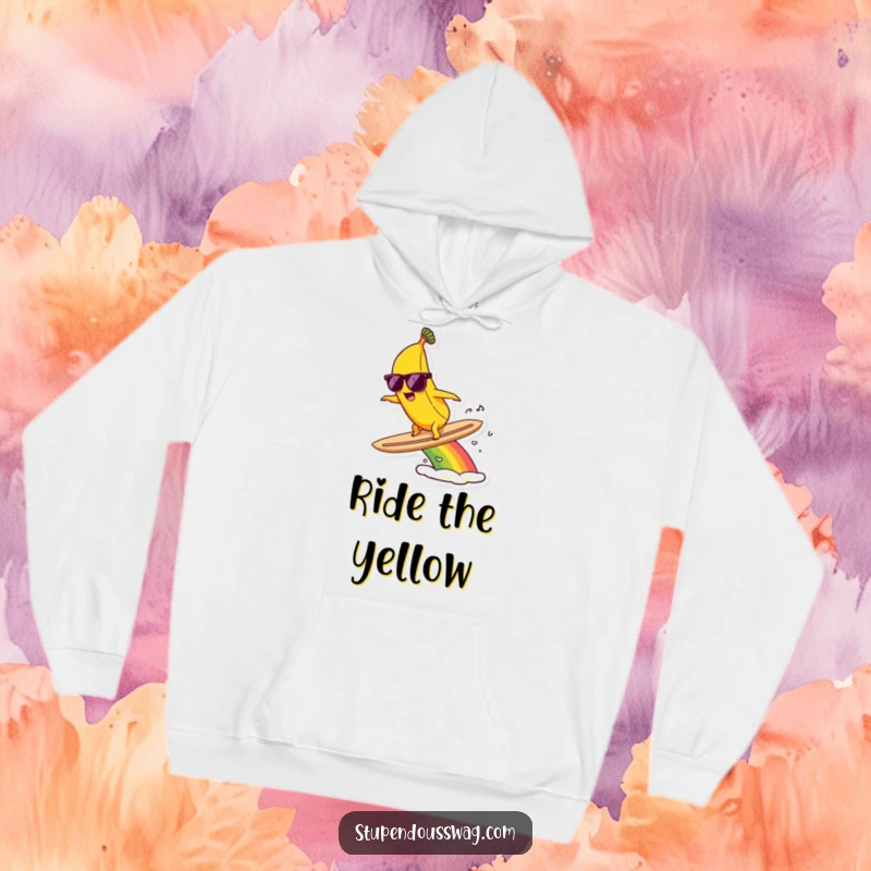 Funny hoodie with a banana in sunglasses surfing a colorful rainbow, embodying ultimate coolness and fun.