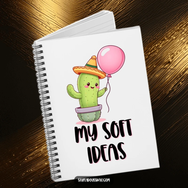 Funny notebook with a cactus wearing a tiny sombrero attempting to hug a balloon, ideal for capturing notes with a touch of sweetness.
