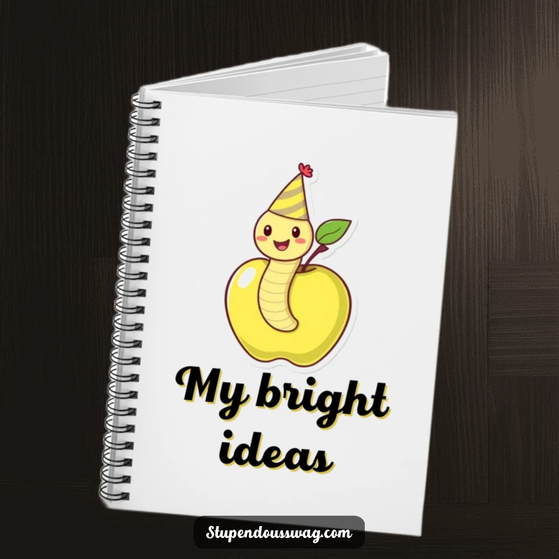 Funny notebook cover with a happy worm wearing a party hat emerging from an apple, encouraging festive and humorous note-taking.