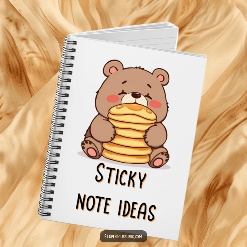 A notebook cover featuring a clumsy bear balancing pancakes, perfect for jotting down notes, recipes, or funny observations.